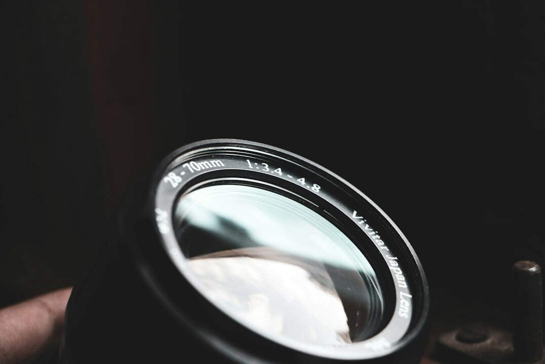 Magnifying glass over printed documents and photographs