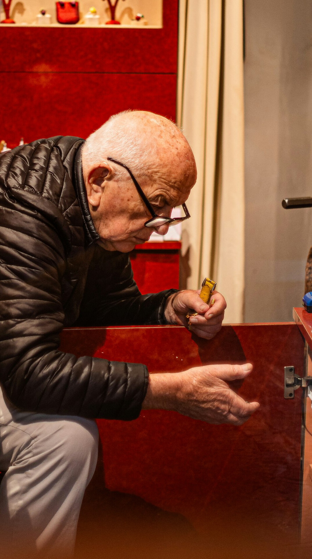 Senior editor examining printed evidence with a magnifying glass